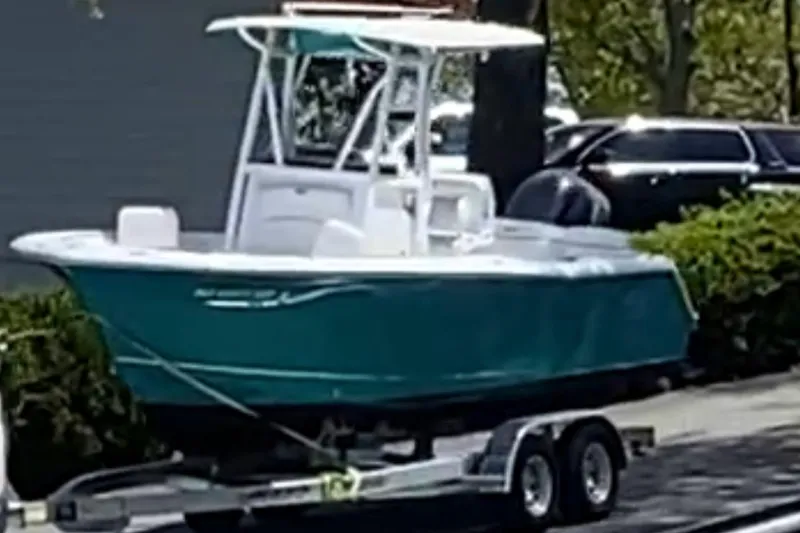 Slide: The Image of 2021 Sea Hunt Ultra 229 boat on trailer, turquoise. - 5