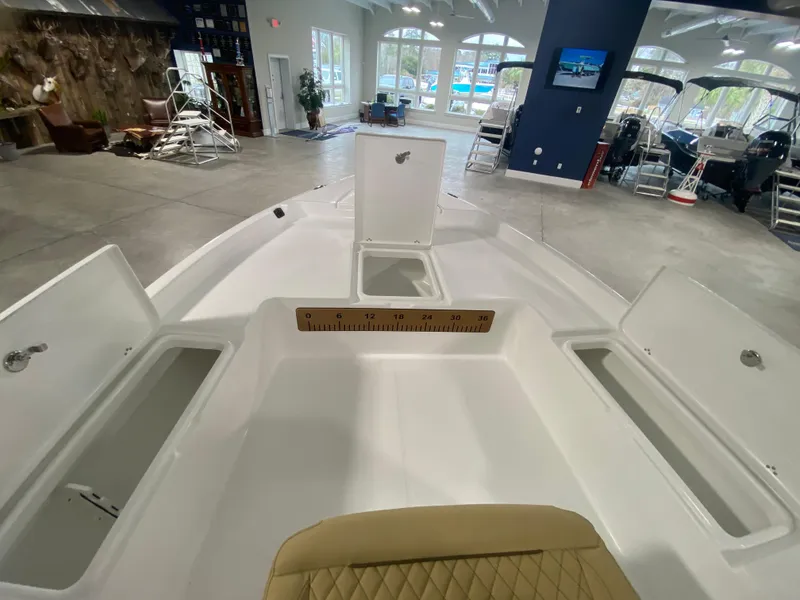 Slide: The Image of 2024 Savannah 210X boat interior with open storage compartments in a showroom. - 15