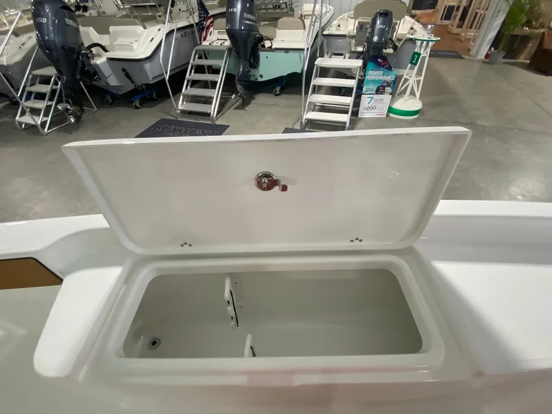 Slide: The Image of Open storage compartment on a 2024 Savannah 210X boat in a showroom. - 18