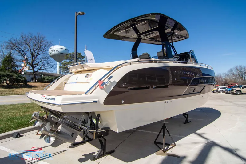 Slide: The Image of 2024 Invictus GT320 luxury boat on display at a marina under clear blue skies. - 13