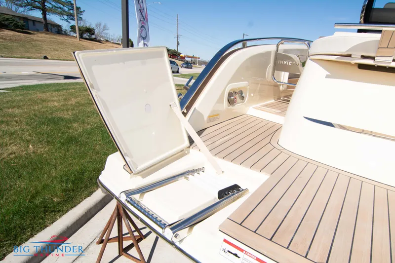 Slide: The Image of 2024 Invictus GT320 yacht with open hatch and swim ladder on deck. - 17