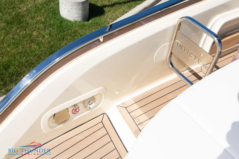 Slide: The Image of 2024 Invictus GT320 boat deck with teak flooring and stainless steel railing. - 20