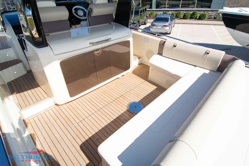 Slide: The Image of 2024 Invictus GT320 boat interior with teak flooring and cushioned seating. - 23