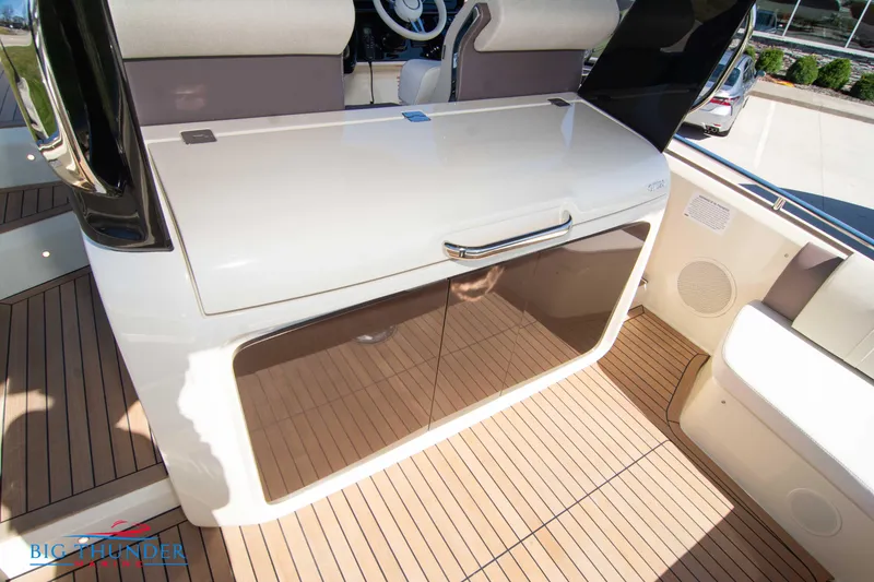 Slide: The Image of 2024 Invictus GT320 boat interior with sleek cabinetry and teak flooring. - 26