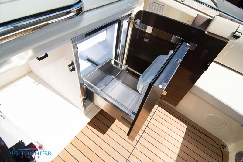 Slide: The Image of 2024 Invictus GT320 boat interior with open storage compartment and wooden flooring. - 29