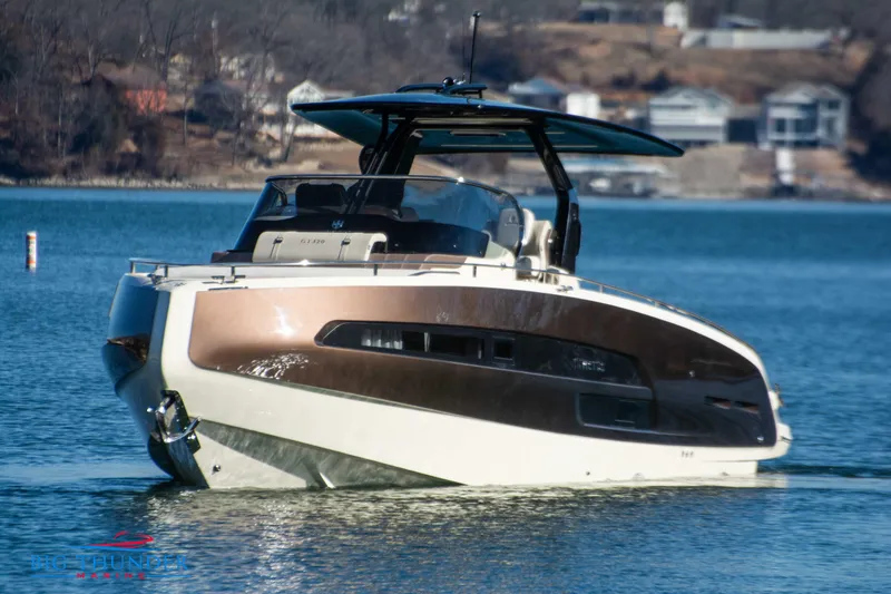 Slide: The Image of 2024 Invictus GT320 luxury yacht on a serene lake with houses in the background. - 3