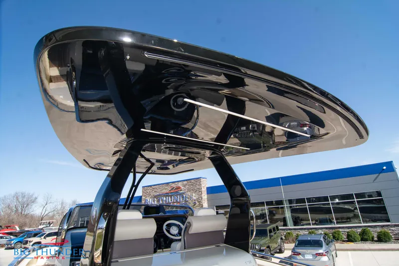 Slide: The Image of 2024 Invictus GT320 boat with sleek black hardtop at a dealership. - 30