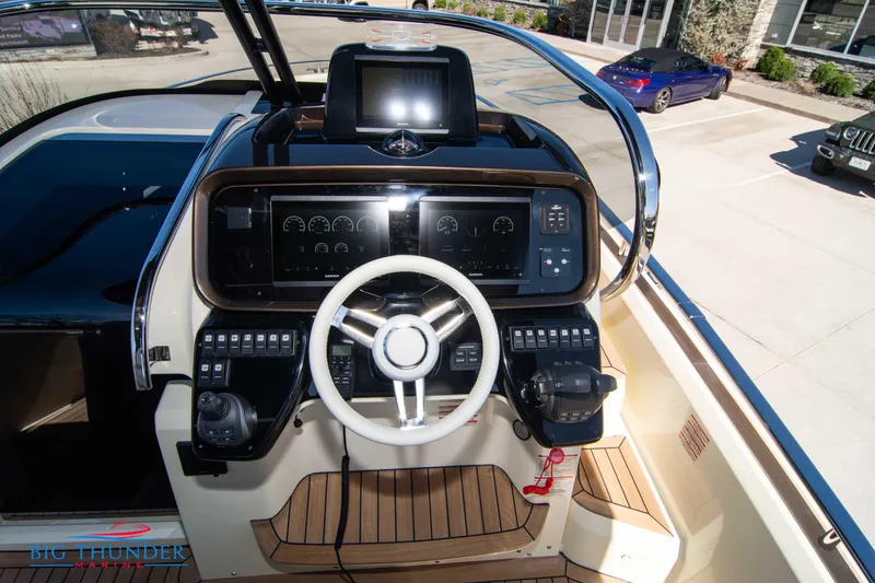 Slide: The Image of 2024 Invictus GT320 boat helm with modern controls and steering wheel. - 32