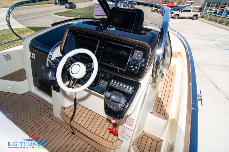 Slide: The Image of 2024 Invictus GT320 boat dashboard with modern controls and steering wheel at Big Thunder Marine. - 34