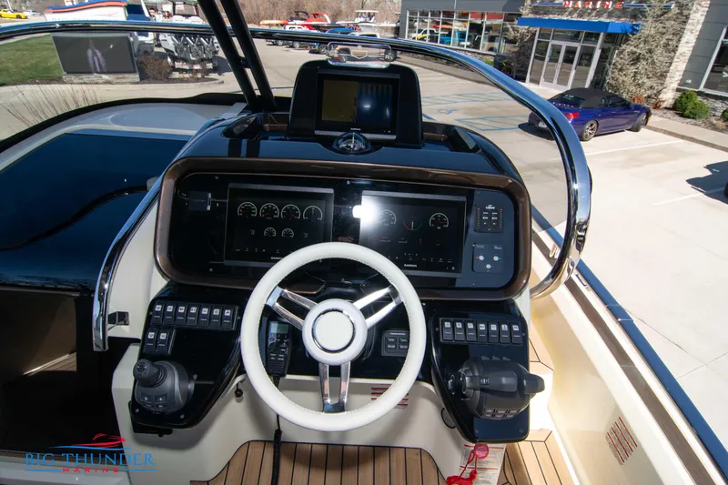Slide: The Image of 2024 Invictus GT320 boat dashboard with steering wheel and control panel. - 35
