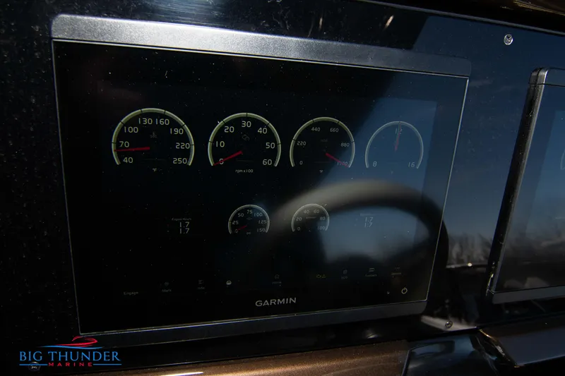 Slide: The Image of 2024 Invictus GT320 dashboard with Garmin display and gauges at Big Thunder Marine. - 38