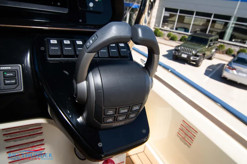 Slide: The Image of Close-up of the 2024 Invictus GT320 boat throttle control system. - 47