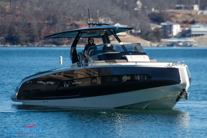 Slide: The Image of 2024 Invictus GT320 luxury motor yacht cruising on a serene lake. - 5