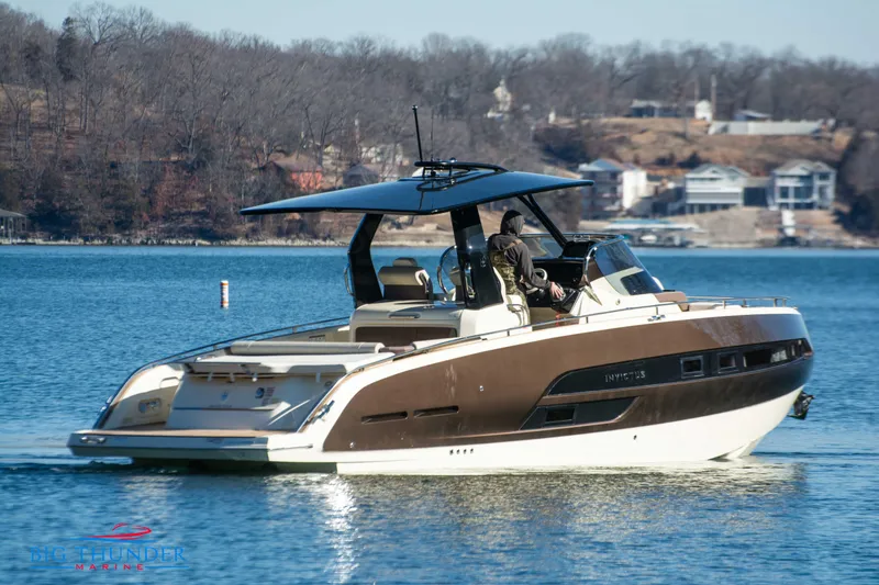 Slide: The Image of 2024 Invictus GT320 luxury motorboat cruising on a serene lake. - 7