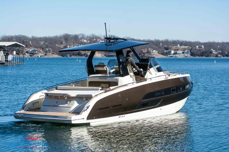 Slide: The Image of 2024 Invictus GT320 luxury motorboat on a serene lake. - 8