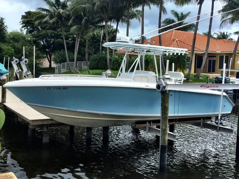 The Image of 2005 Jupiter FS boat docked near waterfront homes with palm trees. - 0