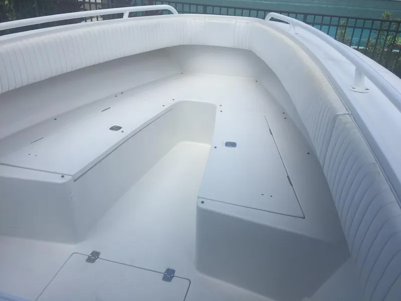 Slide: The Image of 2005 Jupiter FS boat interior with white seating and storage compartments. - 4