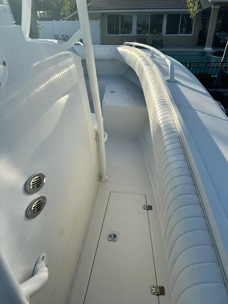 Slide: The Image of 2005 Jupiter FS boat interior with white seating and storage compartments. - 5