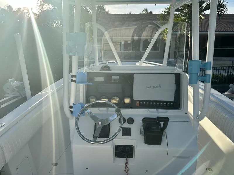 Slide: The Image of 2005 Jupiter FS boat console with Garmin navigation system and steering wheel. - 6