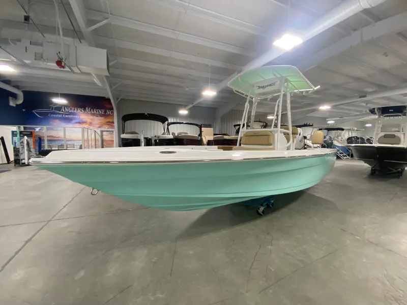 Slide: The Image of 2024 Savannah 210X boat in showroom with mint green hull. - 1