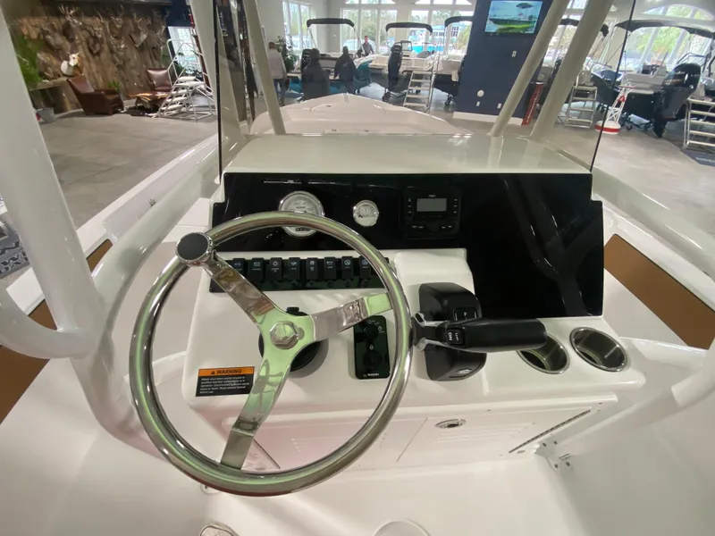 Slide: The Image of 2024 Savannah 210X boat dashboard with steering wheel and control panel. - 11