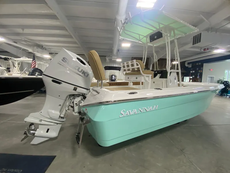 Slide: The Image of 2024 Savannah 210X boat with Suzuki outboard motor in showroom. - 4