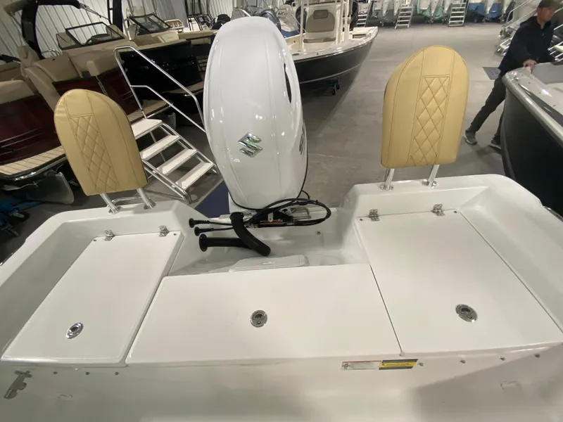 Slide: The Image of 2024 Savannah 210X boat with Suzuki outboard motor in showroom. - 6