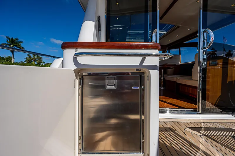 Slide: The Image of 2011 Hunt Yachts 52, stainless steel outdoor fridge, teak deck, and glass sliding doors. - 18