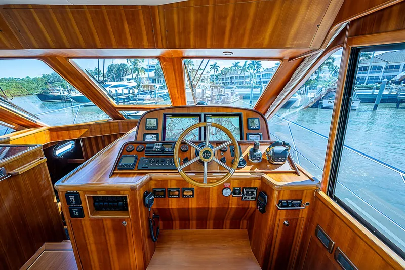 Slide: The Image of Interior helm of 2011 Hunt Yachts 52, featuring wooden dashboard and steering wheel. - 20