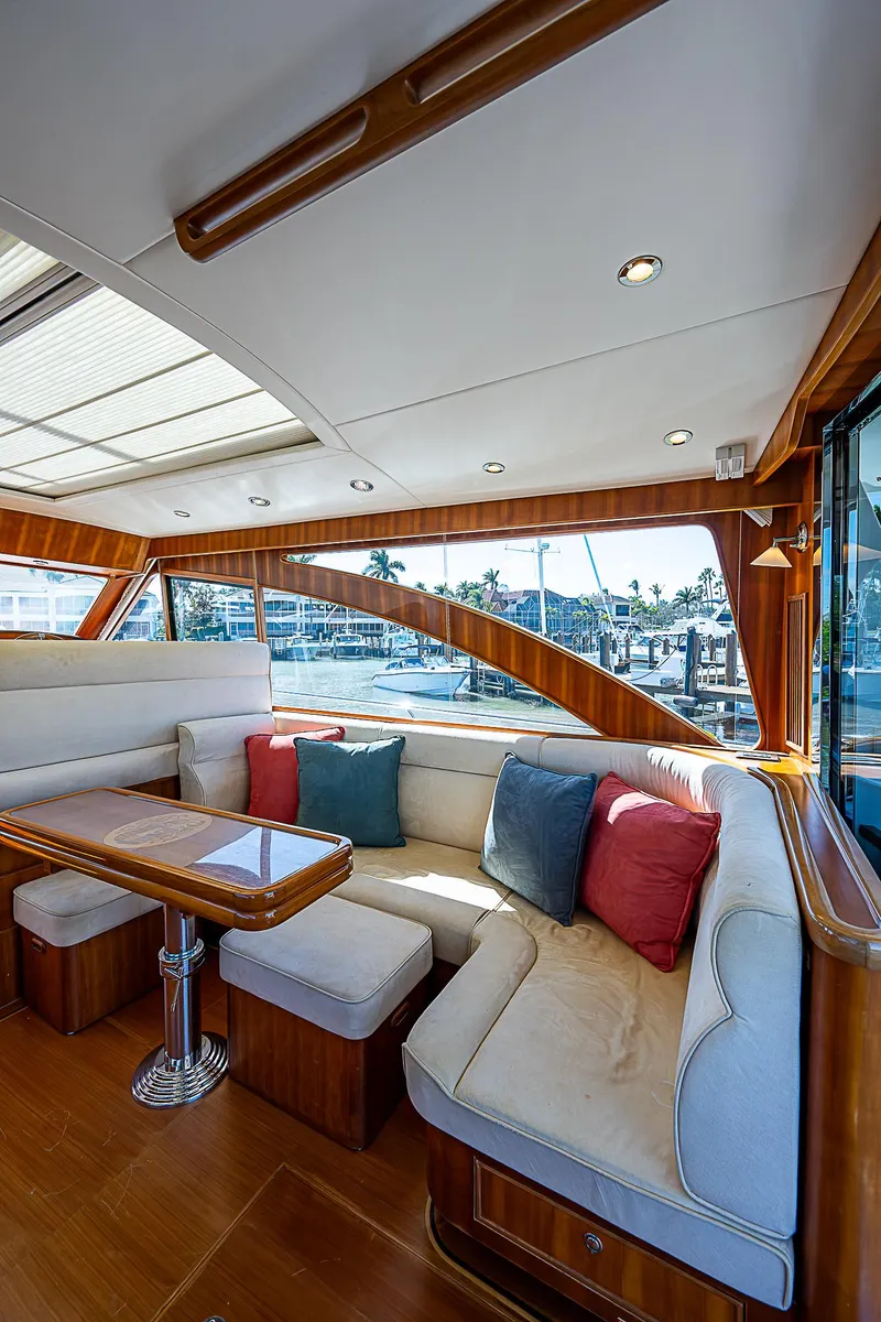 Slide: The Image of 2011 Hunt Yachts 52 interior with plush seating and scenic marina view. - 26