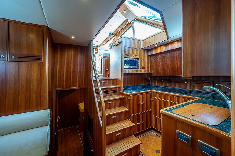 Slide: The Image of 2011 Hunt Yachts 52 interior with wooden cabinetry and modern kitchen. - 30