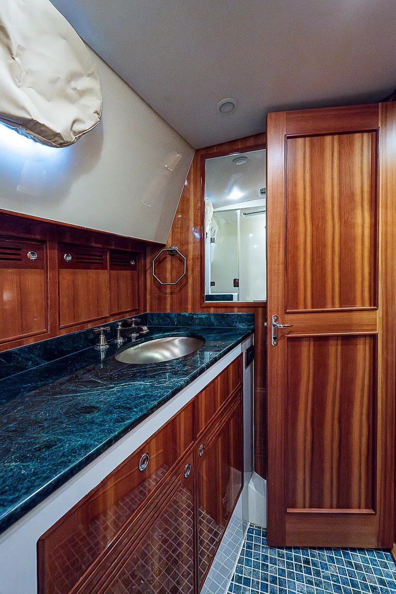 Slide: The Image of Luxurious bathroom in 2011 Hunt Yachts 52 with wooden cabinetry and marble countertop. - 36