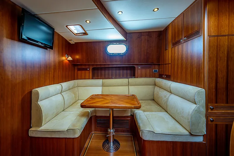 Slide: The Image of Luxurious 2011 Hunt Yachts 52 interior with plush seating and wooden table. - 37