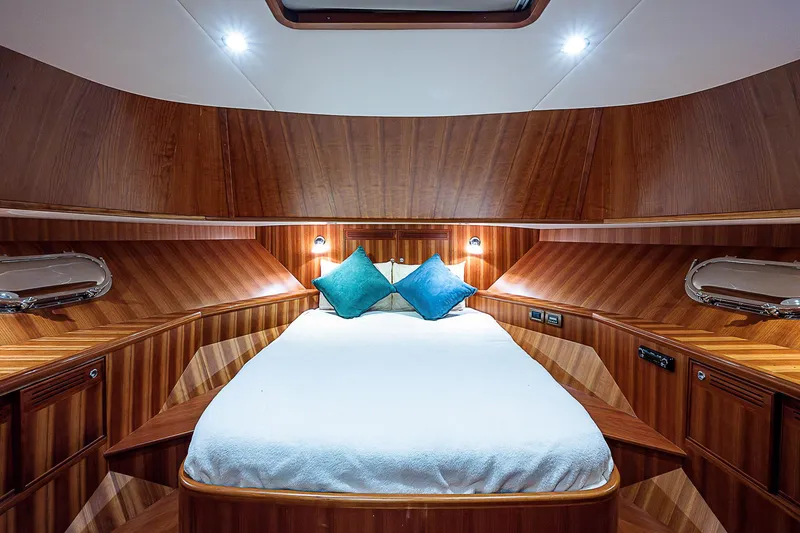 Slide: The Image of Luxurious cabin interior of 2011 Hunt Yachts 52 with wood paneling and cozy bed. - 39