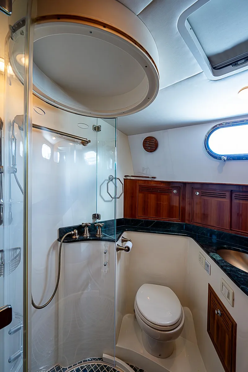 Slide: The Image of Luxurious bathroom in 2011 Hunt Yachts 52 with modern fixtures and wooden cabinetry. - 42