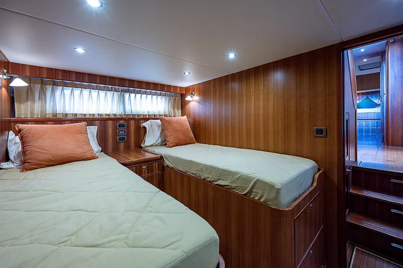 Slide: The Image of Luxurious twin cabin interior of 2011 Hunt Yachts 52 with wooden paneling and ambient lighting. - 45