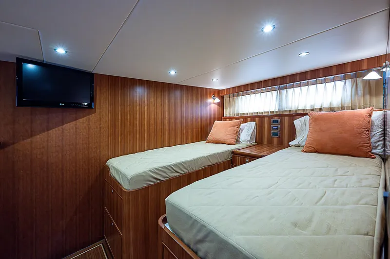 Slide: The Image of 2011 Hunt Yachts 52 interior cabin with twin beds and TV. - 46