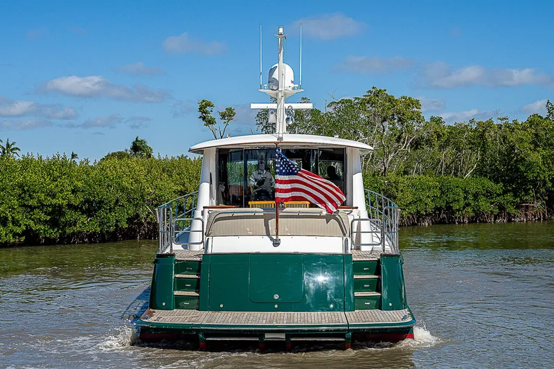 Slide: The Image of 2011 Hunt Yachts 52 cruising in a river with an American flag. - 9