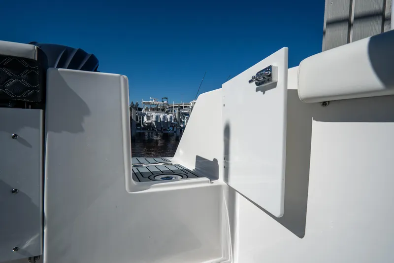 Slide: The Image of 2022 Tidewater 292CC Adventure boat with open side door at the dock. - 10