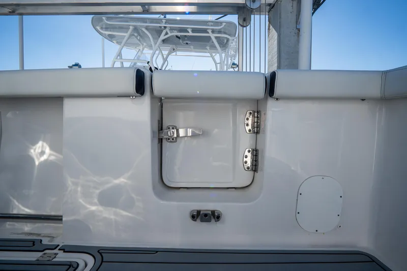 Slide: The Image of 2022 Tidewater 292CC Adventure boat interior, featuring a rear access door. - 13
