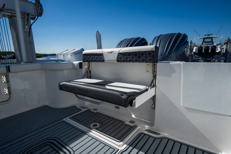 Slide: The Image of 2022 Tidewater 292CC Adventure boat with fold-down seating and twin engines. - 16