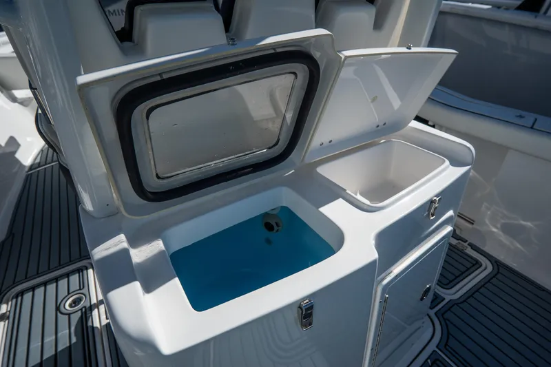 Slide: The Image of 2022 Tidewater 292CC Adventure boat with open storage compartments. - 20