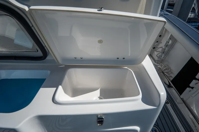 Slide: The Image of Open storage compartment on a 2022 Tidewater 292CC Adventure boat. - 21