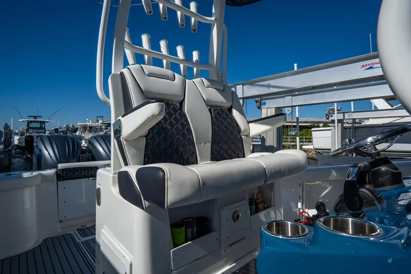 Slide: The Image of 2022 Tidewater 292CC Adventure boat with dual captain's chairs and rod holders. - 27