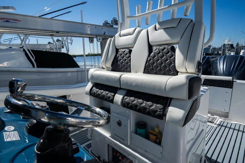 Slide: The Image of 2022 Tidewater 292CC Adventure boat helm with dual seats and steering wheel. - 28