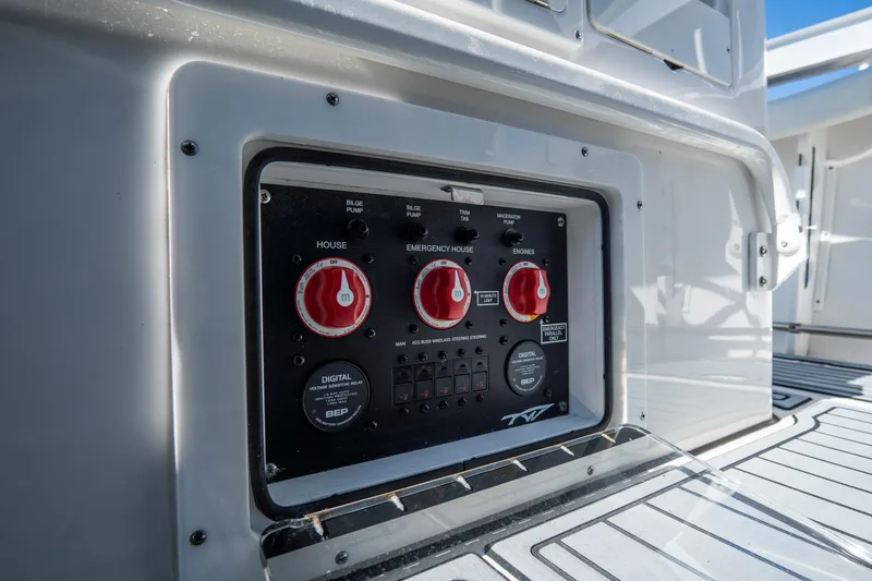 Slide: The Image of Control panel on 2022 Tidewater 292CC Adventure boat, featuring red switches and digital display. - 30