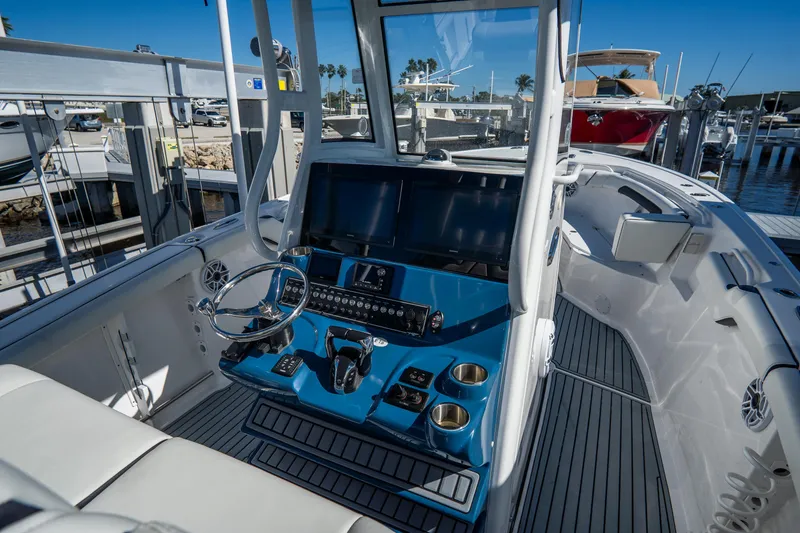 Slide: The Image of 2022 Tidewater 292CC Adventure boat cockpit with modern controls and sleek design. - 31