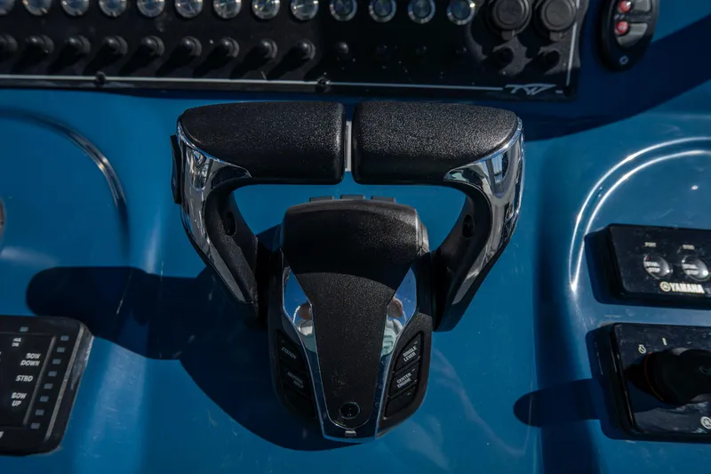 Slide: The Image of Throttle controls on a 2022 Tidewater 292CC Adventure boat dashboard. - 32