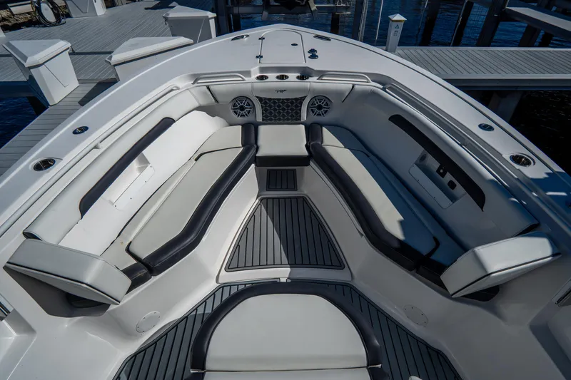 Slide: The Image of 2022 Tidewater 292CC Adventure boat interior with cushioned seating and modern design. - 38