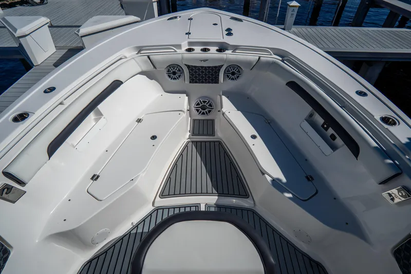 Slide: The Image of 2022 Tidewater 292CC Adventure boat interior with seating and speakers at dock. - 39
